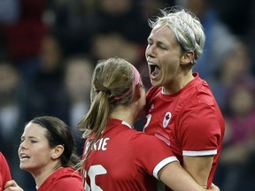 Canada's Sophie Schmidt, right, celebrates with Janine Beckie after scoring her team's goal during the 1-0 quarterfinal victory over France in Sao Paulo on Aug. 12.