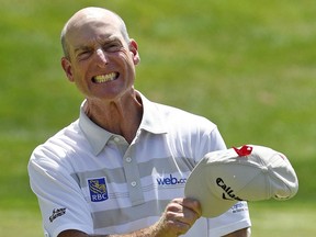 Jim Furyk celebrates after shooting a course and PGA-record 58 during the final round of the Travelers Championship golf tournament in Cromwell, Conn., Sunday, Aug. 7, 2016.