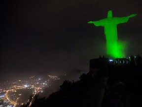 The Christ the Redeemer statue is lit up in green as a symbolic warning of the dangers of climate change in September 2014.