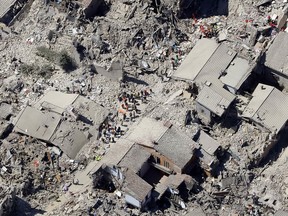 Rescuers search amid rubble following an earthquake in Amatrice Italy, Wednesday, Aug. 24, 2016.