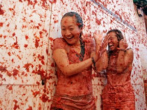 Two women enjoy the annual "Tomatina" tomato fight fiesta in the village of Bunol, 50 kilometres outside Valencia, Spain, on August 31, 2016.