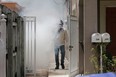 A Miami-Dade County mosquito control worker sprays around a home in the Wynwood area of Miami on Aug. 1, 2016. As Florida has its first reported case of Zika virus transmitted by mosquitoes on the U.S. mainland, here's what Canadians need to know.