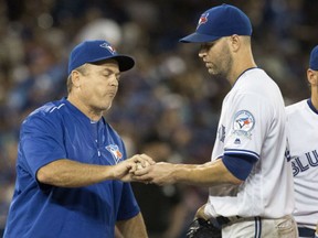 Toronto Blue Jays manager John Gibbons takes the ball from starting pitcher J.A. Happ during the sixth inning of their 6-3 loss against the Los Angeles Angels in Toronto on Thursday.