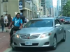 A video shows a driver for Ambassador Taxi swerving into a cyclist.