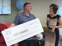 Bill Laharty accepts his oversized novelty cheque for $21-million.