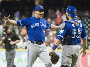 Toronto Blue Jays relief pitcher Roberto Osuna, left, celebrates with catcher Russell Martin after the 4-1 win over the Houston Astros on Thursday.