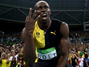 Usain Bolt of Jamaica celebrates after winning the men's 4 x 100m relay final.