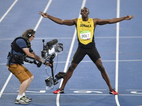 Usain Bolt from Jamaica celebrates winning the gold medal in the men's 200-meter final.