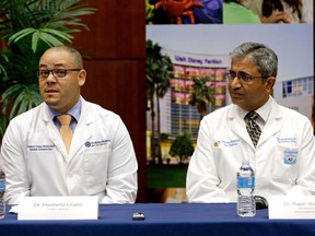 Dr. Humberto Liraino, left, makes comments during a news conference as Dr. Rajan Wadhawan listens, at Florida Hospital, Tuesday, Aug. 23, 2016, in Orlando, Fla. The doctor spoke about the treatment of Sebastian DeLeon, a patient that has survived a brain-eating amoeba that kills most people who contract it. (AP Photo/John Raoux)