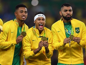 Neymar (centre), celebrates with teammates after their received their gold medals for winning the men's soccer tournament on Saturday, Aug. 20, 2016.