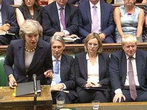 British Prime Minister Theresa May, left, speaks during Question Time in the House of Commons on July 20.