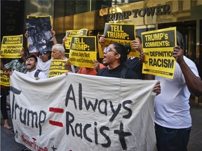 Anti-Trump protesters demonstrate outside a meeting between Donald Trump and minority Republicans at Trump Tower, Thursday Aug. 25, 2016, in New York.