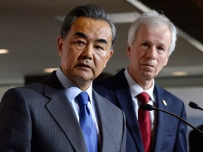 Chinese Foreign Minister Wang Yi, left, and Foreign Affairs Minister Stéphane Dion hold a press conference in Ottawa on June 1.