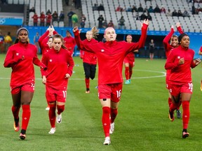 Canada's players warm up before the quarter-final match against  France.