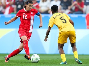 Christine Sinclair of Canada is marked by Emmaculate Msipa of Zimbabwe during Saturday's women's match at Corinthians Arena in Sao Paulo, Brazil.