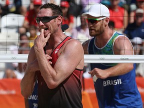 Josh Binstock of Canada shows his dejection against the men's Brazilian beach volleyball team.