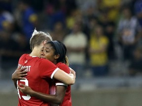 Sophie Schmidt, left, consoles Ashley Lawrence after their semifinal loss to Germany at the Mineirao Stadium in Belo Horizonte, Brazil on Tuesday, Aug. 16, 2016.