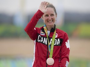 Canada's Catharine Pendrel celebrates her bronze medal in women's mountain bike at the 2016 Olympic Games in Rio de Janeiro, Brazil, on Saturday, Aug. 20, 2016.
