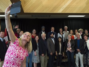Minister of Environment and Climate Change Catherine McKenna, left, takes a selfie with members of the Liberal cabinet at their retreat in Sudbury, Ont., on Sunday, August 21, 2016.