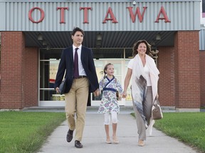 Canadian Prime Minister Justin Trudeau, his wife Sophie Gregoire, and daughter Ella-Grace walk to board a government plane in Ottawa.