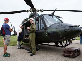 Capt. Sam Jeffery, right, chats about the Griffon CH-146 helicopter during the Edmonton Airshow on Aug. 7.