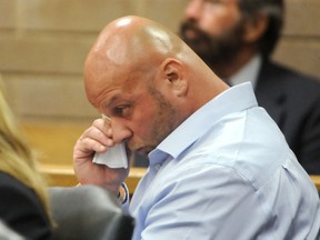 Johnny Small wipes his eyes during a hearing before Judge W. Douglas Parsons at the New Hanover County Courthouse in Wilmington, N.C., Monday, Aug. 8, 2016