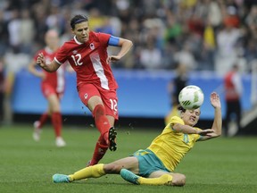 Canada's Christine Sinclair, left, scores her team's second goal against Australia in Canada's opening match of Rio 2016 on Aug. 3.