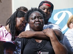 Matrice Stanley, centre, sister of Donnell Thompson, speaks to reporters in downtown Los Angeles, Tuesday after the Sheriff's Department acknowledged that her brother was mistakenly identified as a carjacker when he was shot and killed.