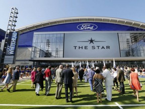 People make their way inside The Star, the Dallas Cowboys new headquarters at The Star in Frisco, Tex., Sunday. The Cowboys had their first workday at their new practice facility _ part-headquarters, part-spa, part-museum with amenities the players probably couldn’t have imagined at aging Valley Ranch.