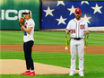 U.S. swimmer Katie Ledecky (left) throws out the first pitch at Wednesday's Washington Nationals game, as Nationals outfielder Bryce Harper holds Ledecky's medals from Rio 2016.