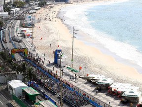 The peleton rides near Copacabana beach at the start line of the men's road cycling race on Saturday, Aug. 6, 2016.
