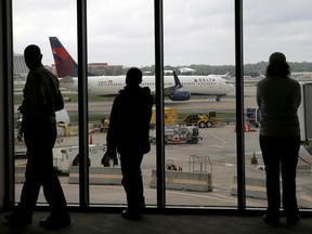 A 2015 file photo of Delta Air Lines passengers watch watching a plane at Atlanta's Hartsfield International Airport in Atlanta