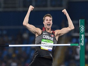 Canada's Derek Drouin celebrates his gold-medal winning jump of 2.38 metres during the Rio Olympics.