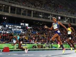 Shaunae Miller of the Bahamas (L) dives over the finish line to win the gold medal in the Women's 400m Final.