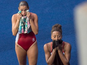 Jennifer Abel (right) and Pamela Ware (left), of Canada, react after just missing the podium in fourth place