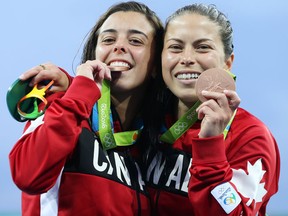 Meaghan Benfeito and Roseline Filion of Canada celebrate their bronze medal