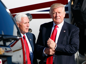 Donald Trump and vice presidential candidate Gov. Mike Pence, R-Ind.,  after landing for a campaign rally, Friday, Aug. 5, 2016, in Green Bay, Wis.
