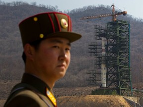 In this April 8, 2012 file photo, a North Korean soldier stands in front of the Unha 3 rocket at a launching site in Tongchang-ri, North Korea.