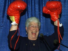Conservative candidate for Saint John, Elsie Wayne, raises her hands after receiving a pair of boxing gloves from a man dressed in a blue Santa suit during her nomination meeting in Saint John, N.B. Monday Oct. 23, 2000.
