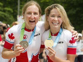 Canadians Catharine Pendrel, right, and Emily Batty show off their silver and gold medals after the women's mountain bike event at the 2015 Pan Am Games.