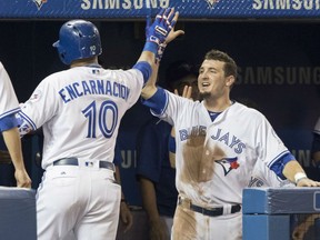 Edwin Encarnacion, left, of the Toronto Blue Jays is congratulated by Darrell Ceciliani after hitting his 300th career homerun against the Houston Astros Friday night at the Rogers Centre. It was Encarnacion's 32nd homer of the season. The Astros were 5-3 winners.