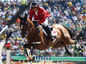 Eric Lamaze of Canada rides Fine Lady 5 during round 2 of the Jumping Team event at the Olympic Equestrian Centre on Wednesday.
