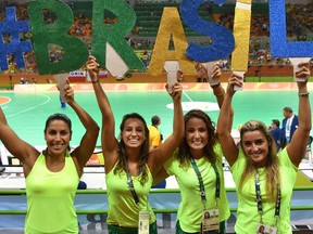 Brazilian fans holds cardboard cut-out letters forming the word "#Brasil" before a handball match