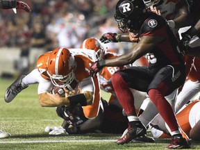 B.C. Lions quarterback Travis Lulay makes a quarterback sneak against the Redblacks defence during second half CFL action on Thursday night in Ottawa.