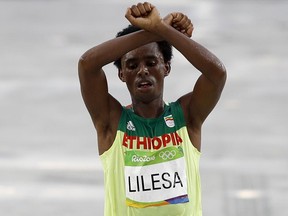 Ethiopia's Feyisa Lilesa crosses the finish line of the men's marathon with his arms crossed during the the 2016 Summer Olympics in Rio de Janeiro on Sunday, Aug. 21, 2016.