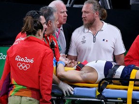 Samir Ait Said of France receives medical attention after breaking his leg while competing on the vault during the Artistic Gymnastics Men's Team qualification.