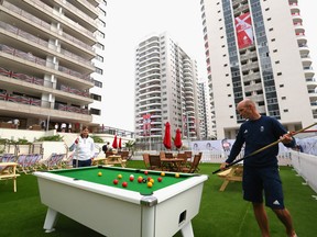 Athletes of Great Britain playing pool at the Olympic Village.