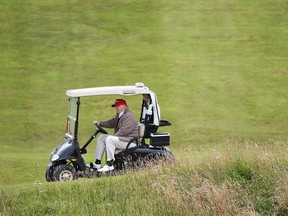 Republican presidential candidate Donald Trump in a golf buggy in a 2015 file photo
