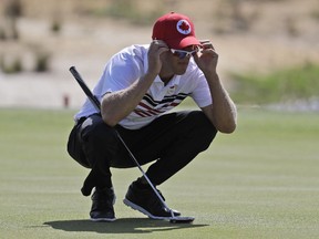 Graham DeLaet of Canada lines up a putt on the second hole during the third round of the men's golf event at the 2016 Summer Olympics in Rio de Janeiro on Saturday, Aug. 13, 2016.