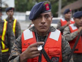 Guatemalan army soldiers stand for review, in Puerto Barrios, Guatemala, Tuesday, Aug. 3, 2016